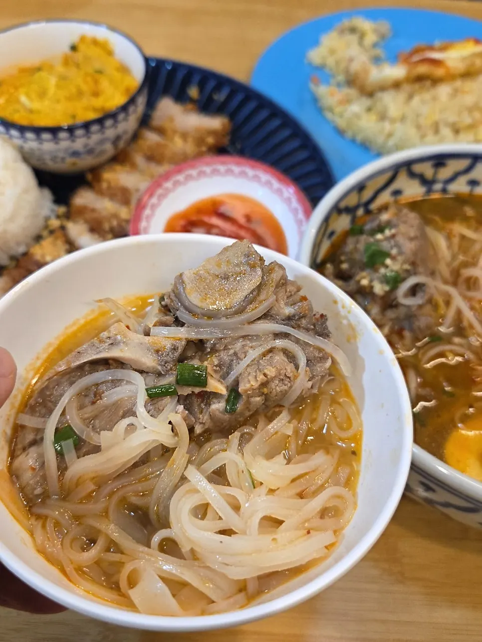 A spoonful of shrimp fried rice eaten alongside the pho