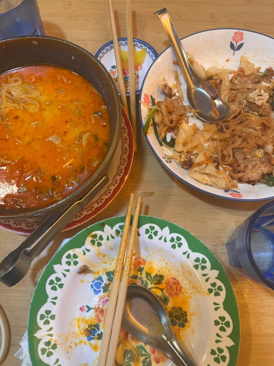 Bowl of curry pho with tripe divided out to share