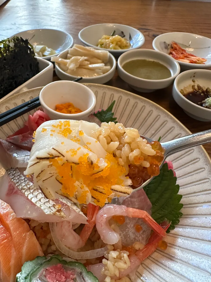 Squid sashimi topped with flying fish roe and salmon roe