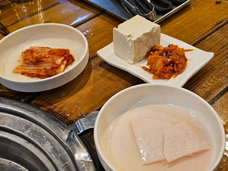 Basic side dishes including dubu-kimchi with whole tofu