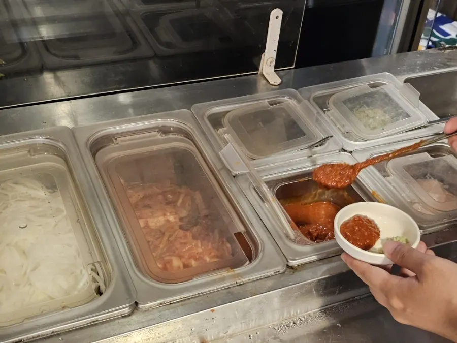 Covered side dish containers at the self-serve bar