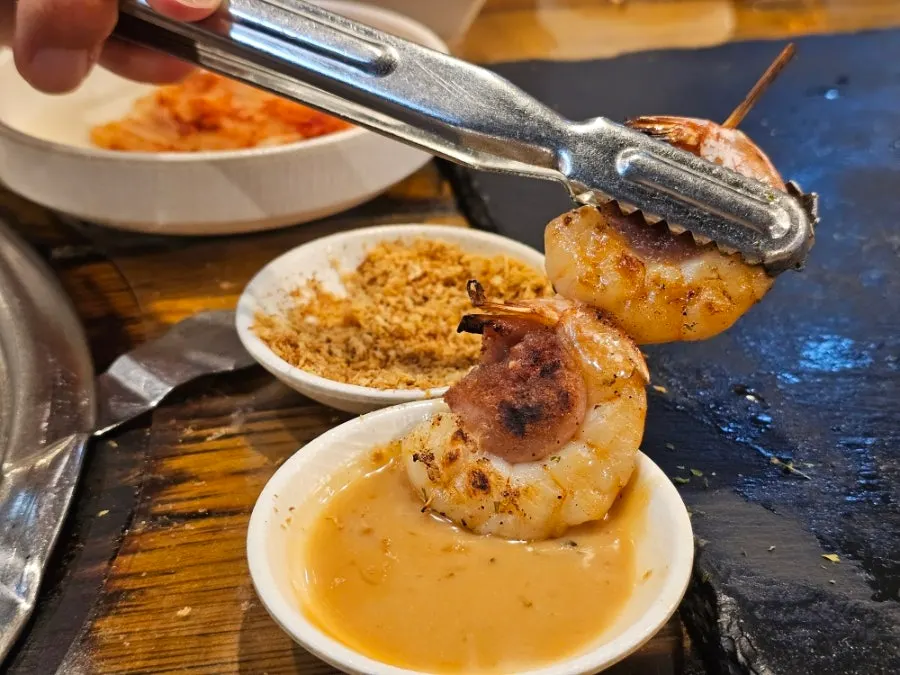 Shrimp-and-sausage skewer dipped in sauce