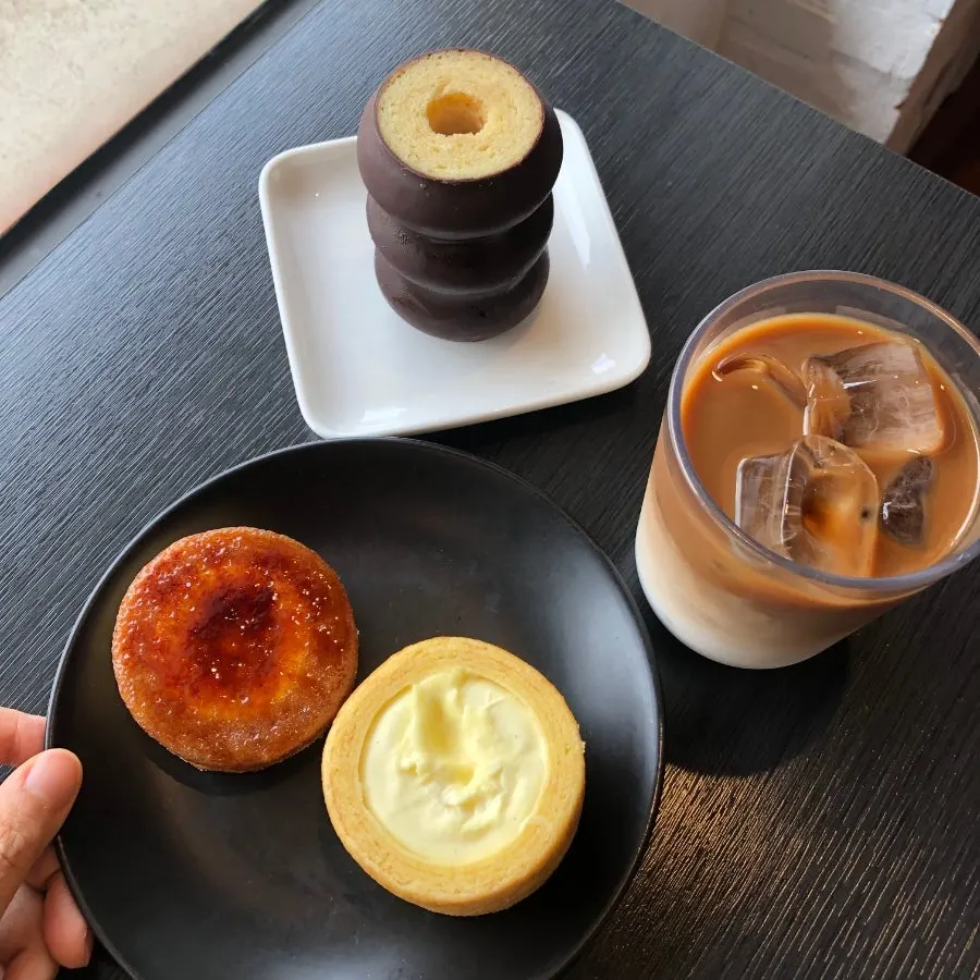 Table with three types of baumkuchen and a cold brew latte