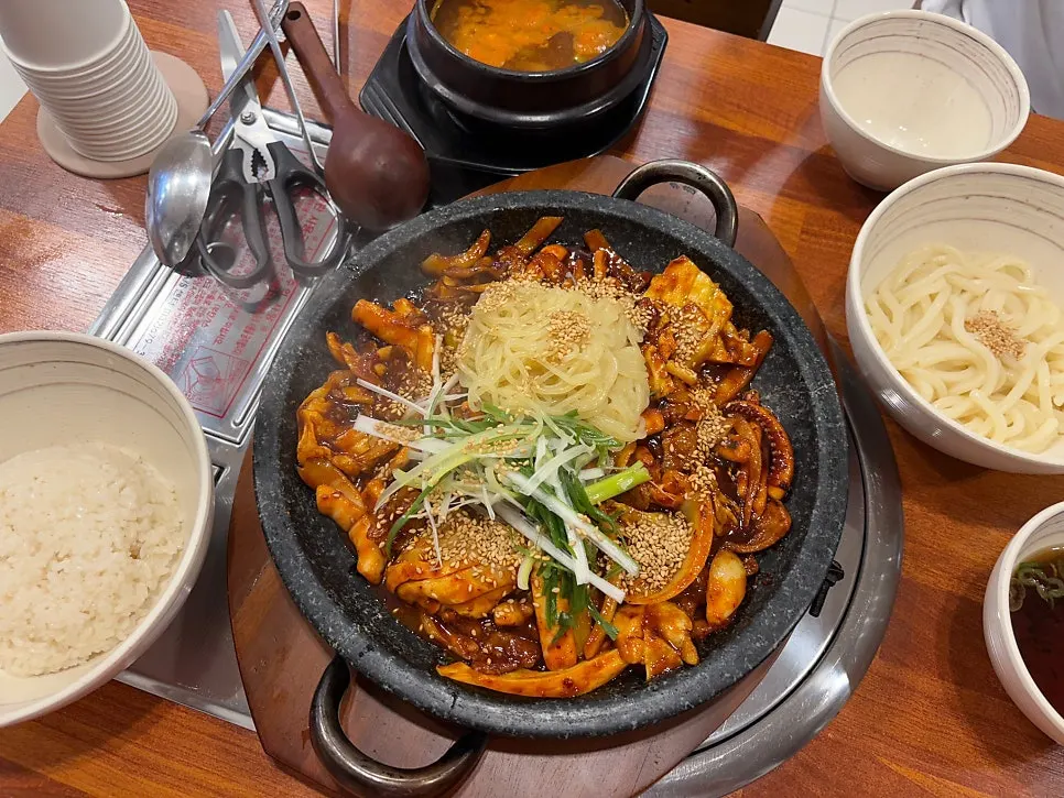 Table set with hotplate oje bokkeum and side dishes