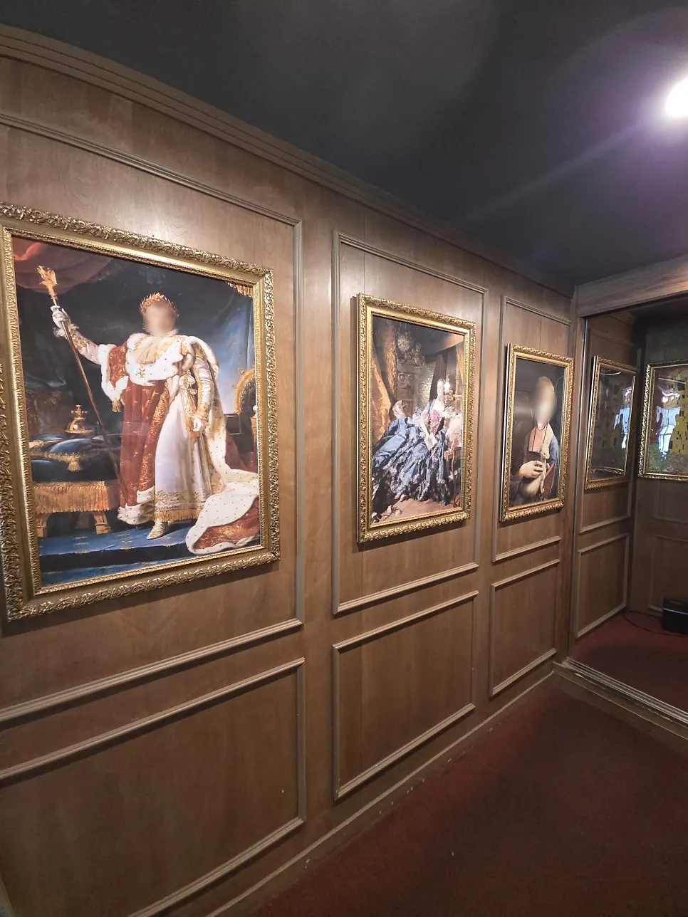 European-style hall decorated with wood-tone walls and framed pictures
