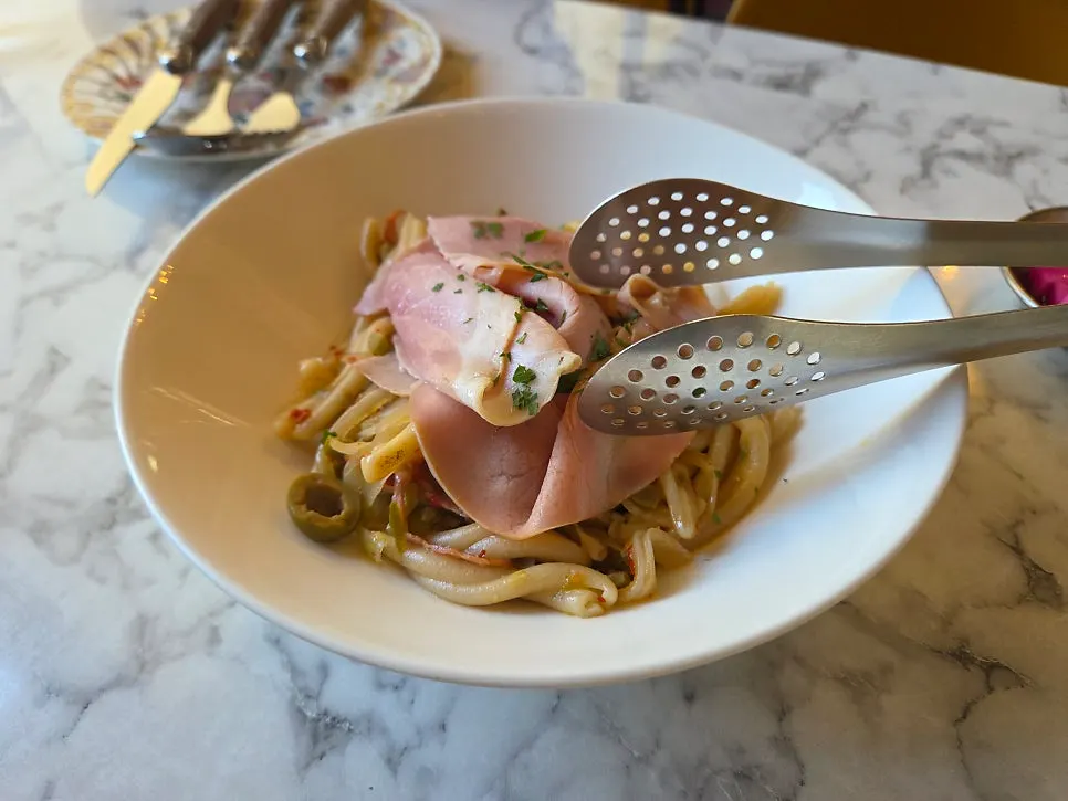Charcuterie oil casarecce fresh pasta served on a plate