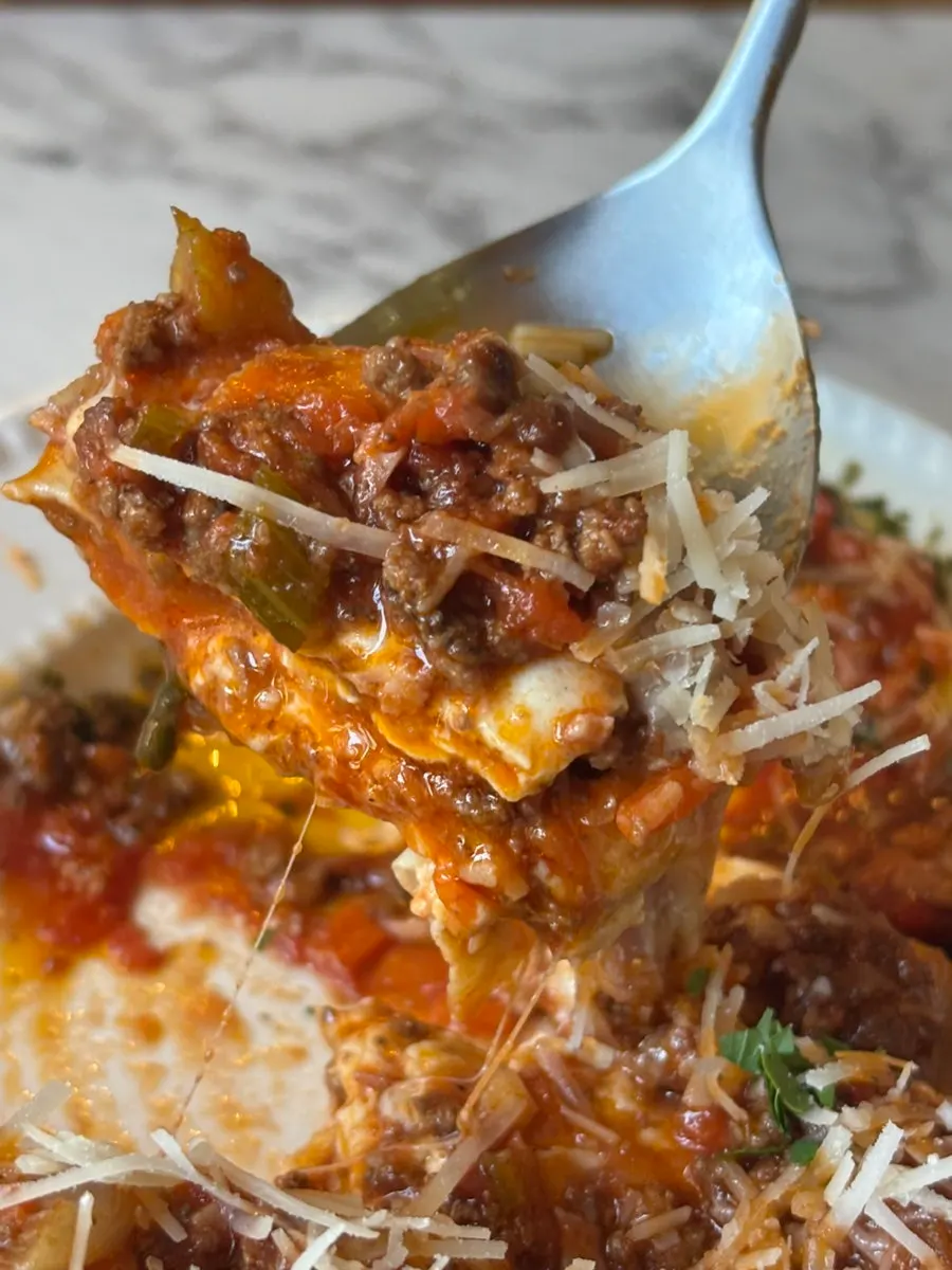 Fresh pasta lasagna topped generously with bolognese sauce and cheese
