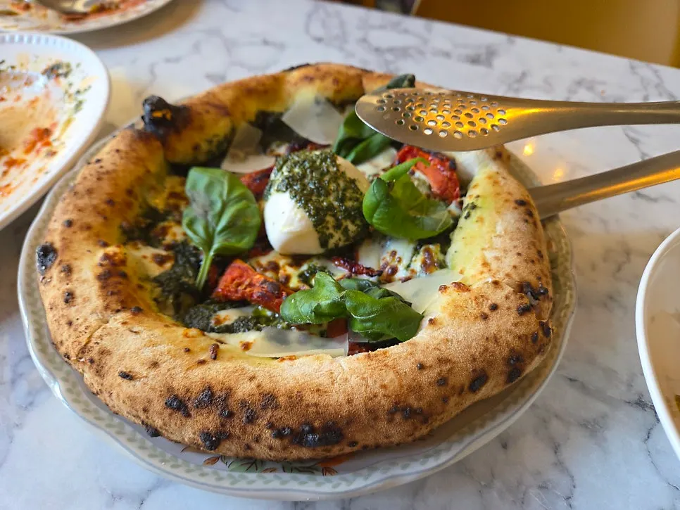 A whole signature basil burrata cheese pizza