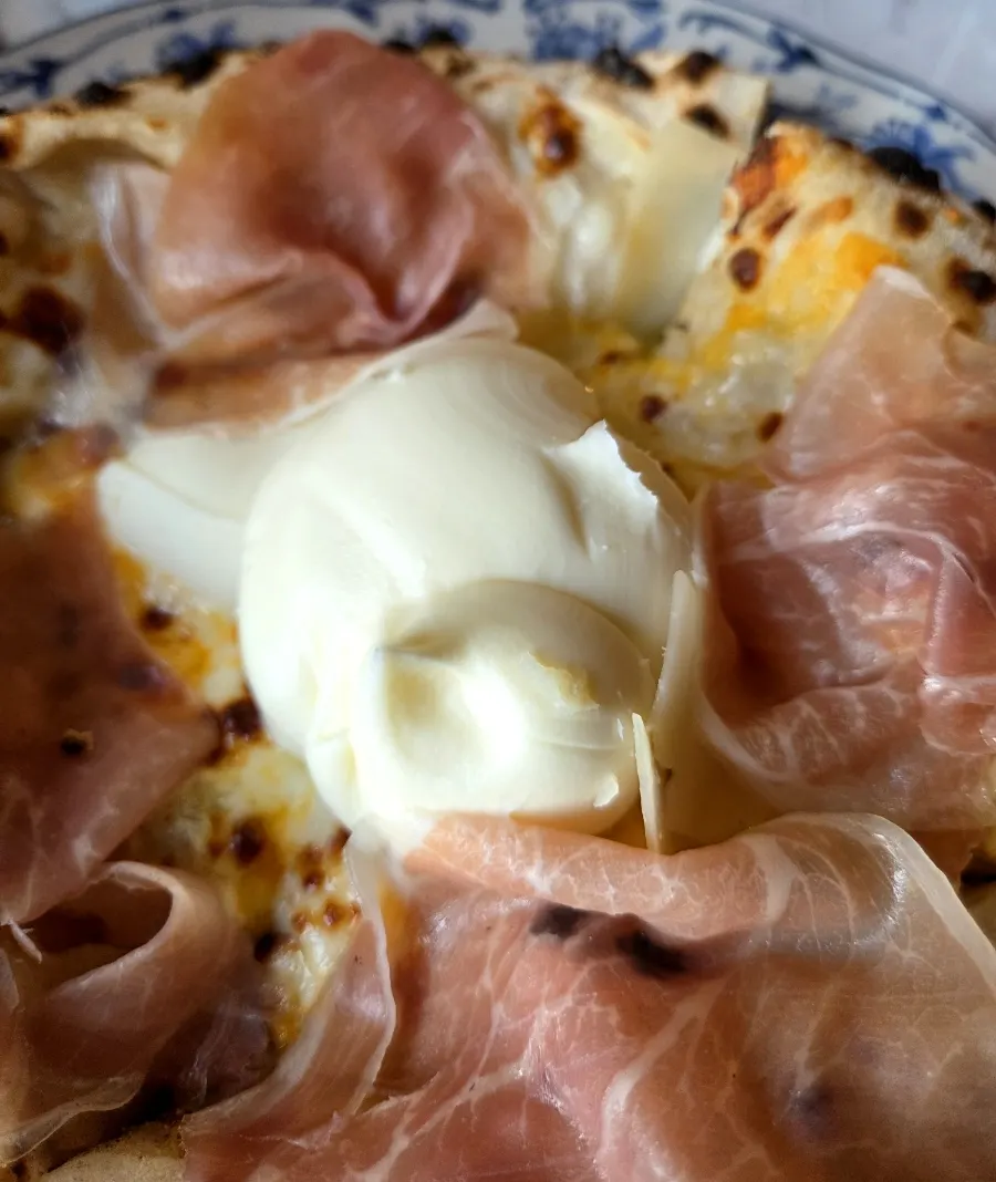 Wood-fired pizza piled high with ricotta cheese