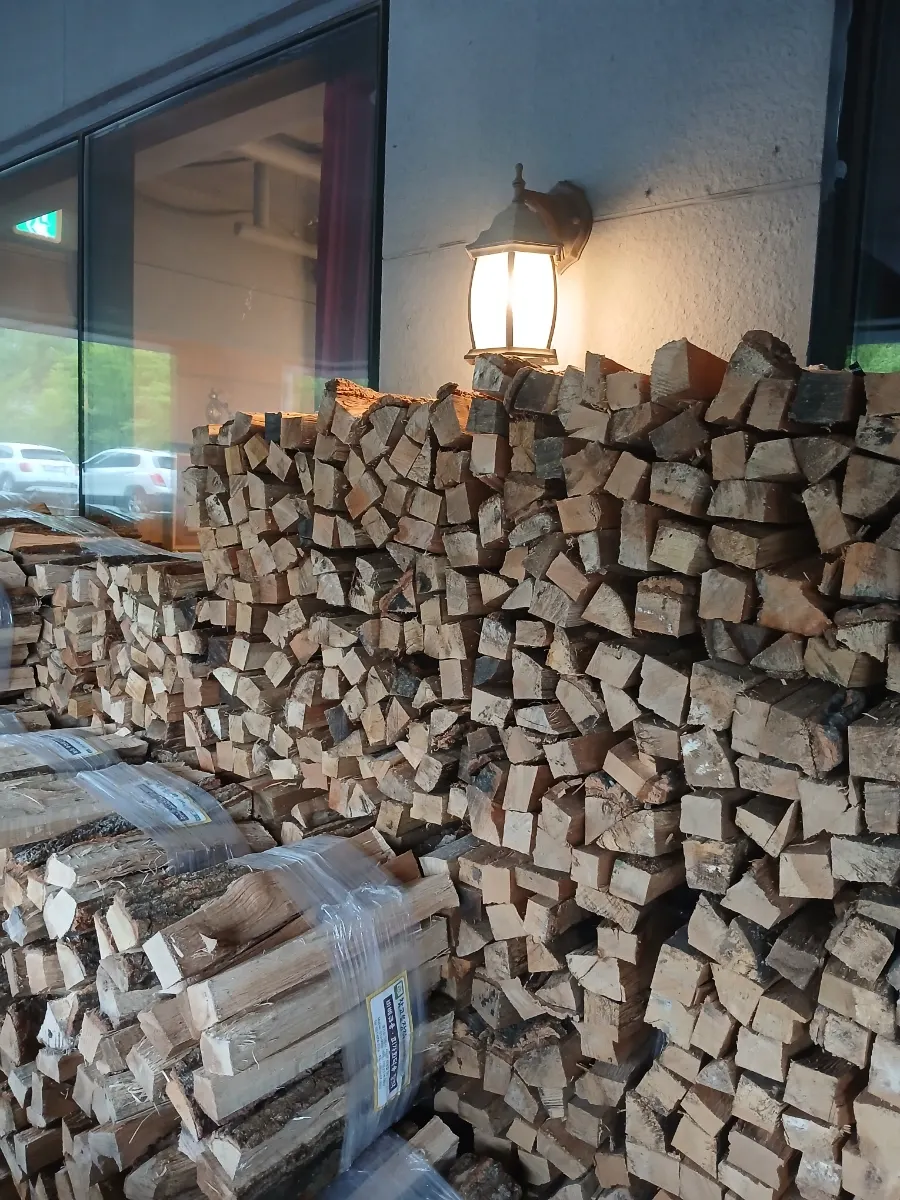 Oak firewood stacked outside the restaurant