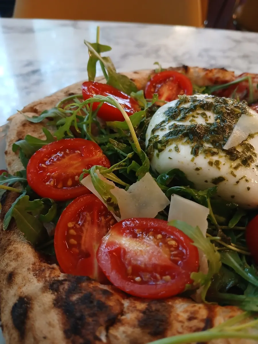 Close-up of rocket pizza topped with burrata cheese