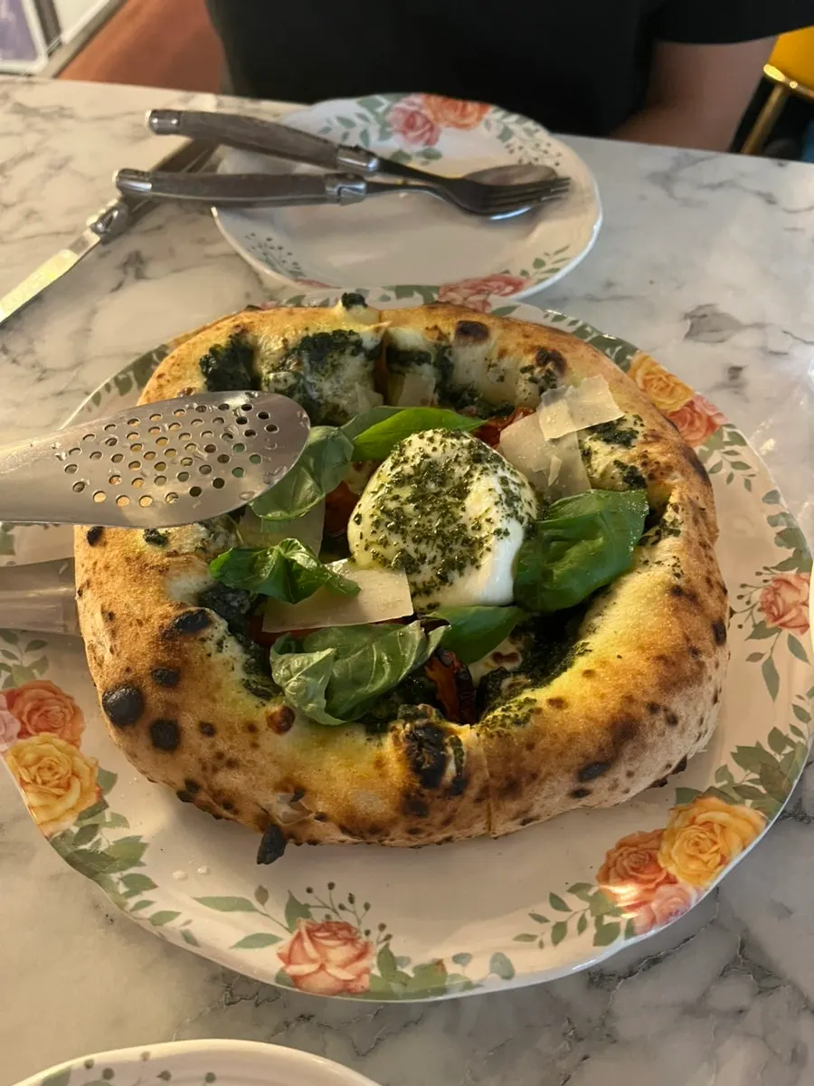 Wood-fired pizza cut into four pieces