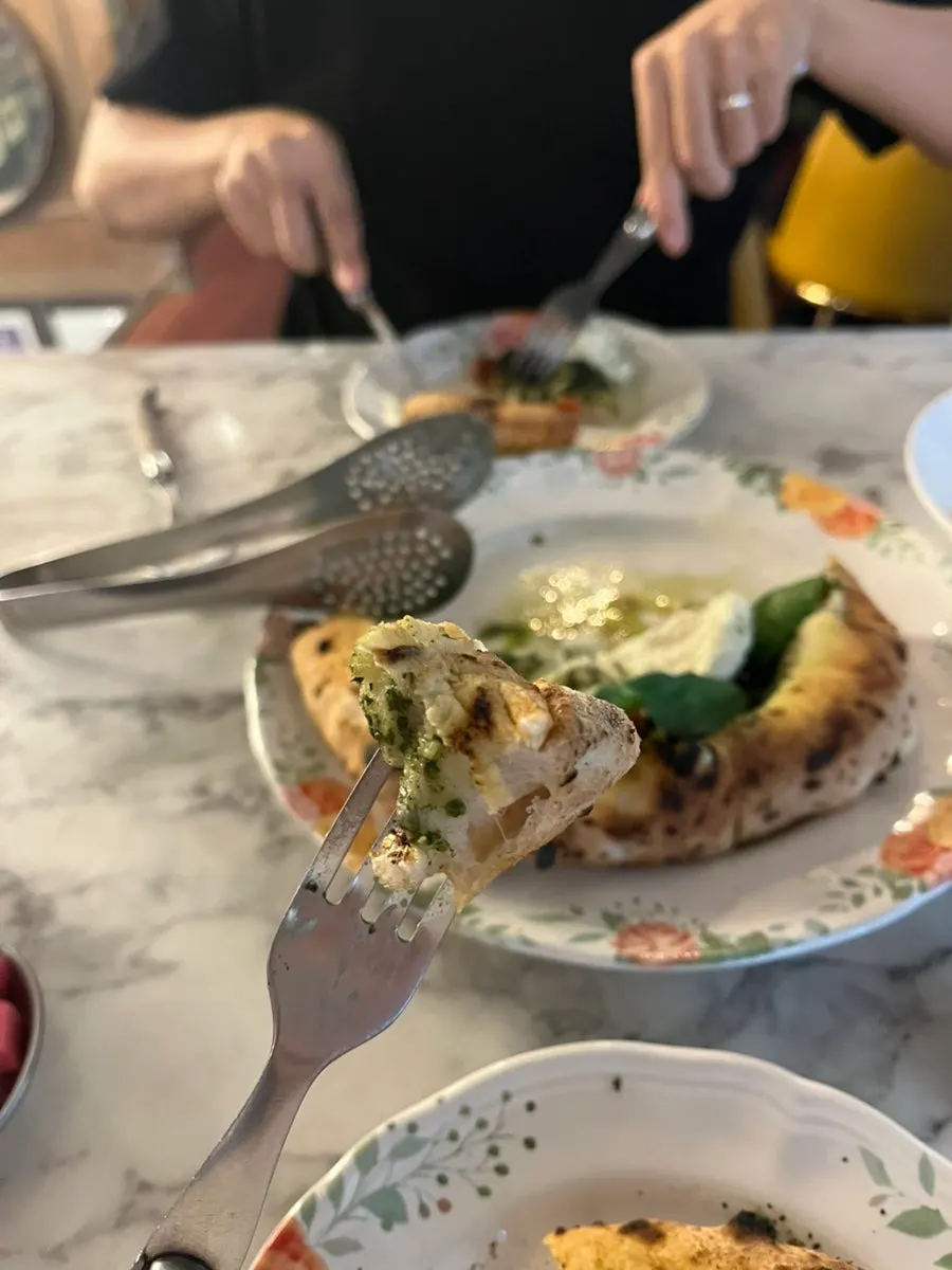 Pizza crust dipped in basil sauce