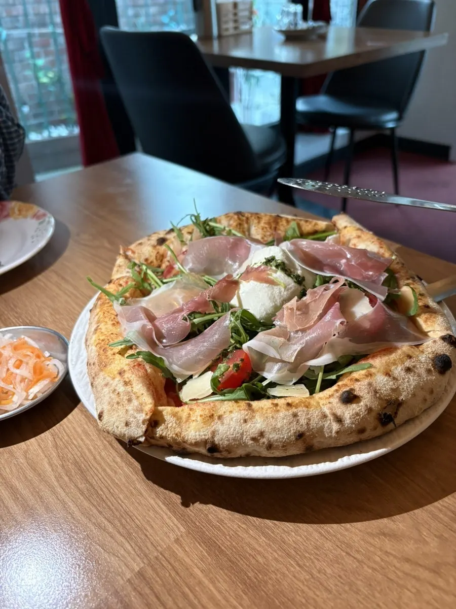 Signature Arugula Jamón Burrata Cheese pizza with lemon sparkling drink