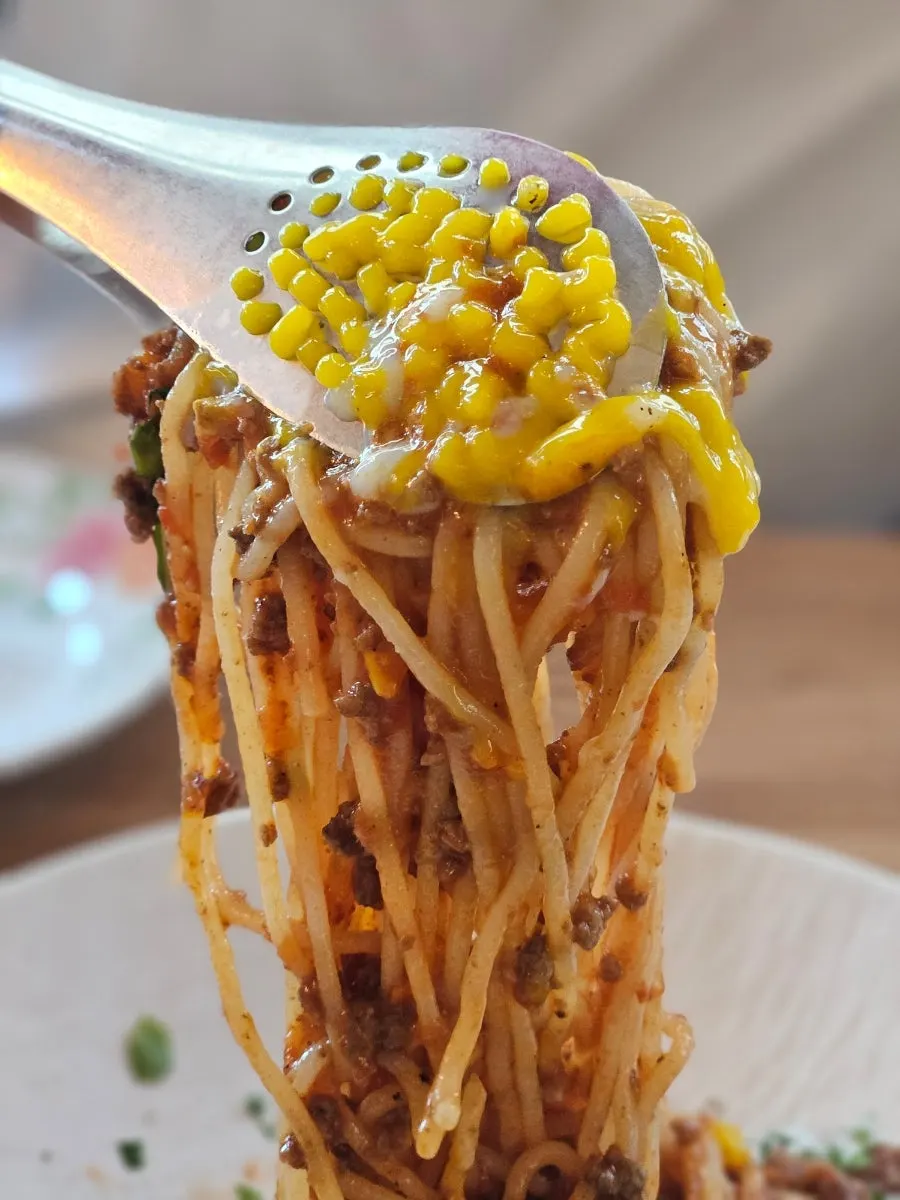 Beef ragu pasta twirled around a fork