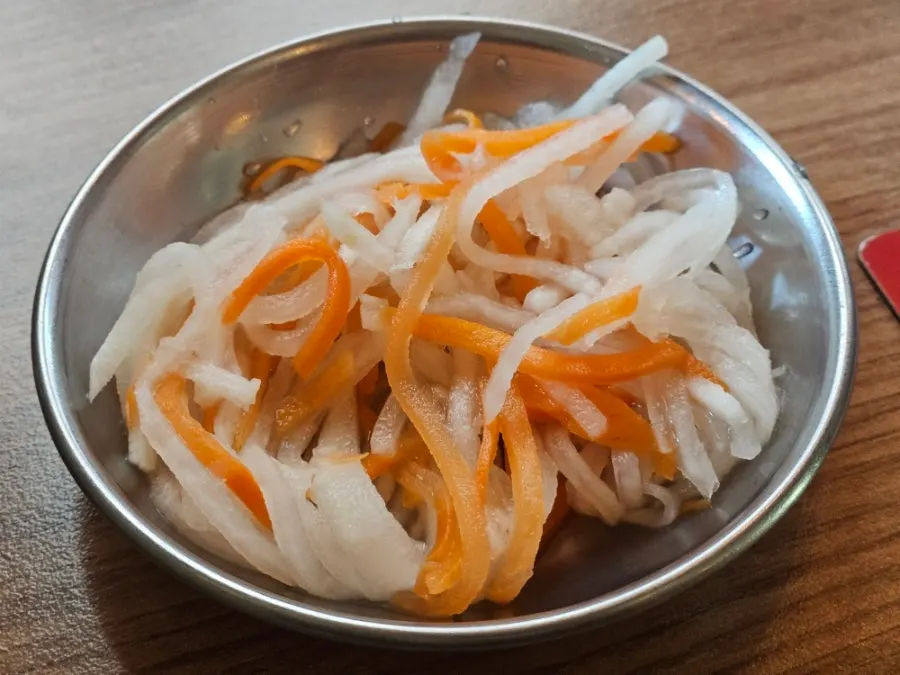 A plate of julienned radish and carrot pickles