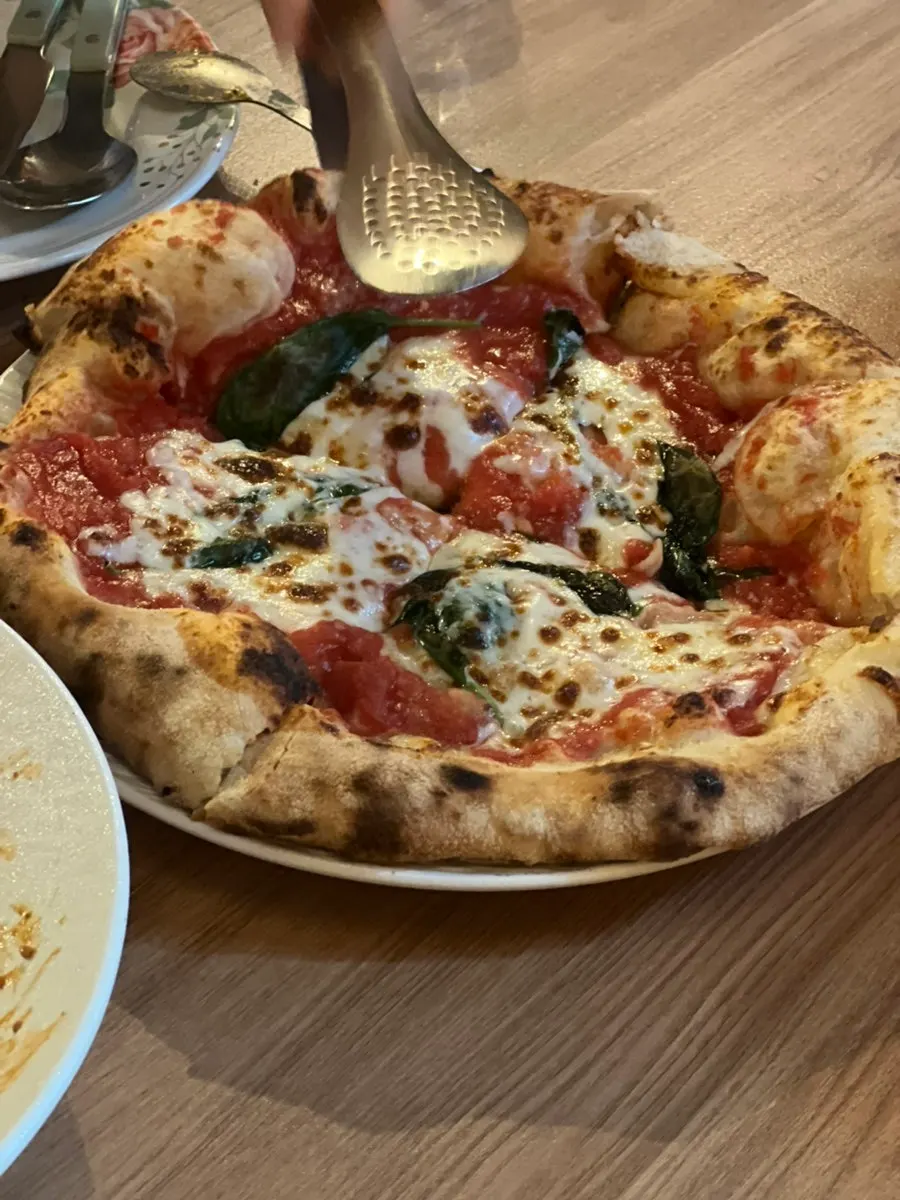 A whole wood-fired Margherita pizza