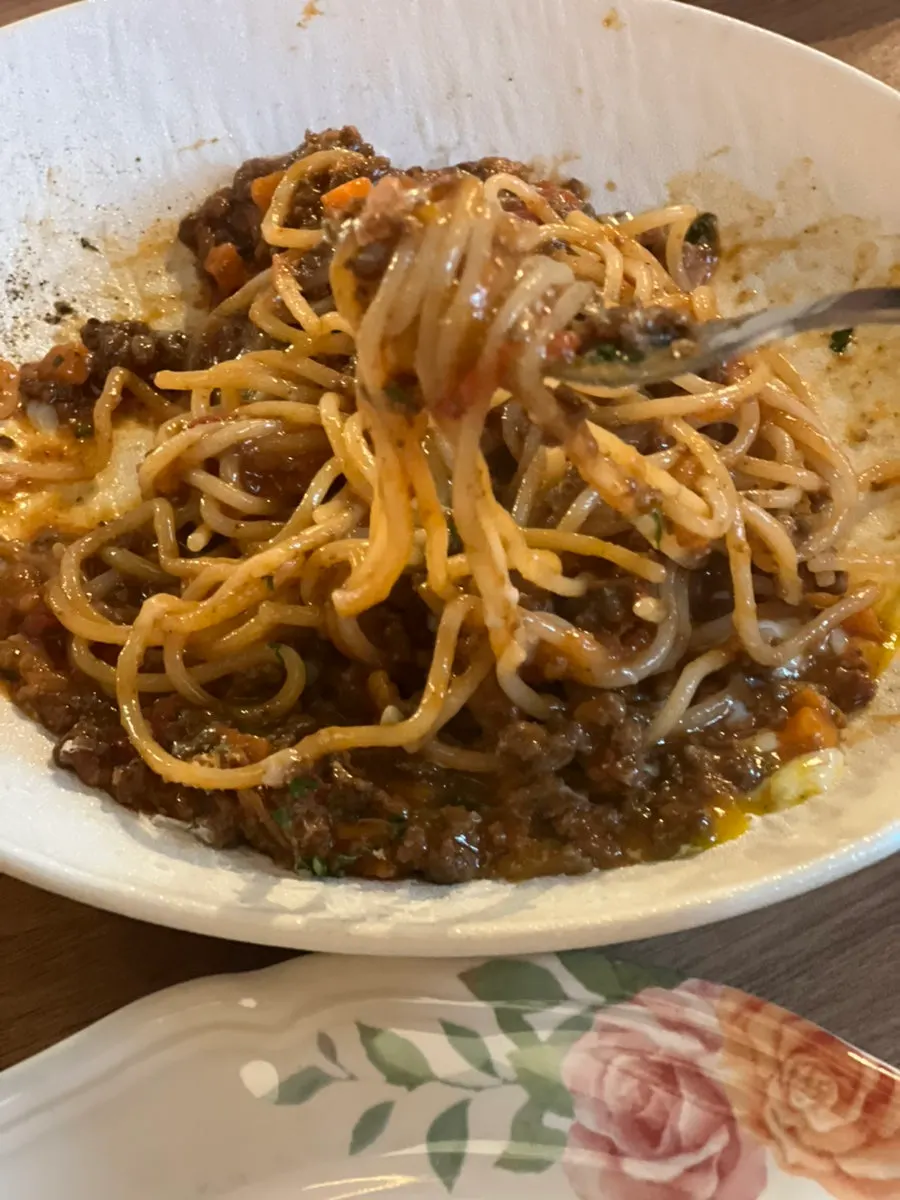 Beef ragu pasta twirled around a fork