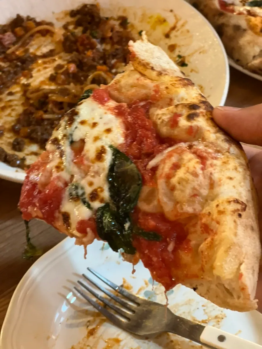 Pizza and pasta placed together on the table