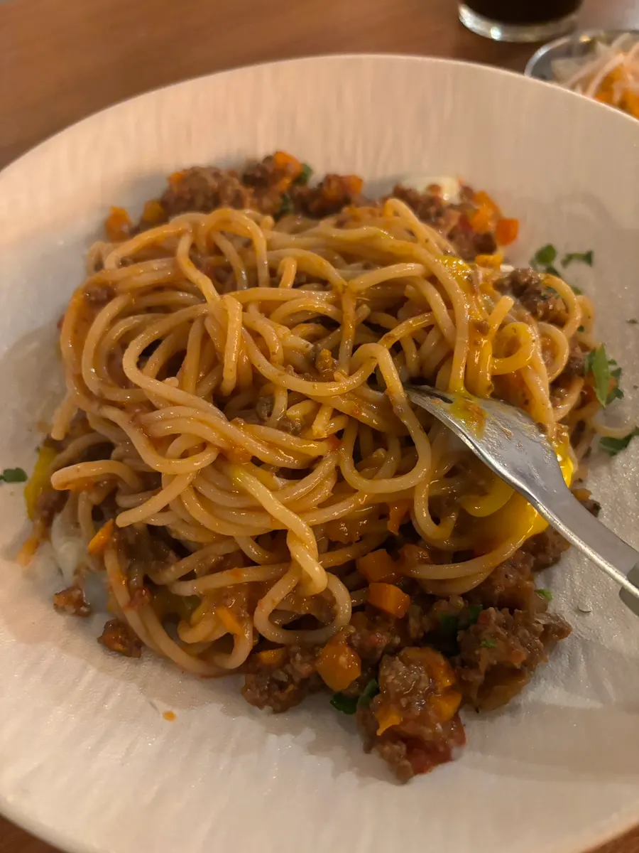 Springy fresh pasta lifted on a fork