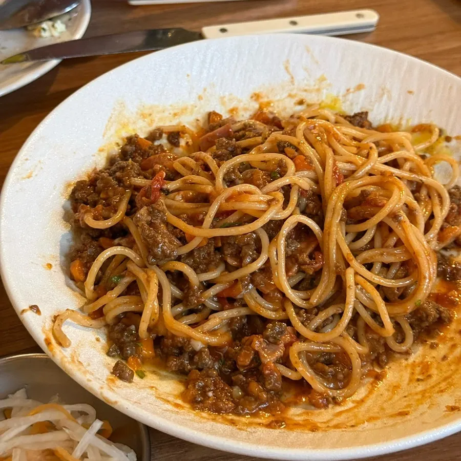 Ragu pasta mixed with the runny poached egg