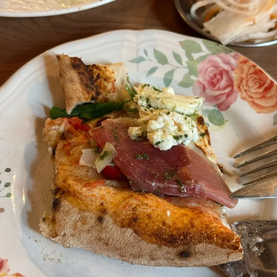 Splitting open the burrata cheese on the pizza