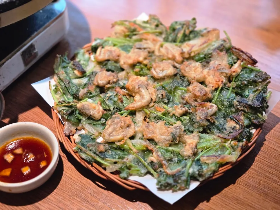 Seasonal cockle and water parsley pancake on a tray