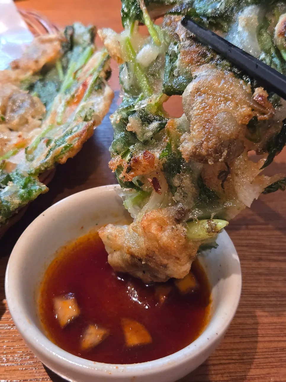 Cockle pancake dipped in soy sauce