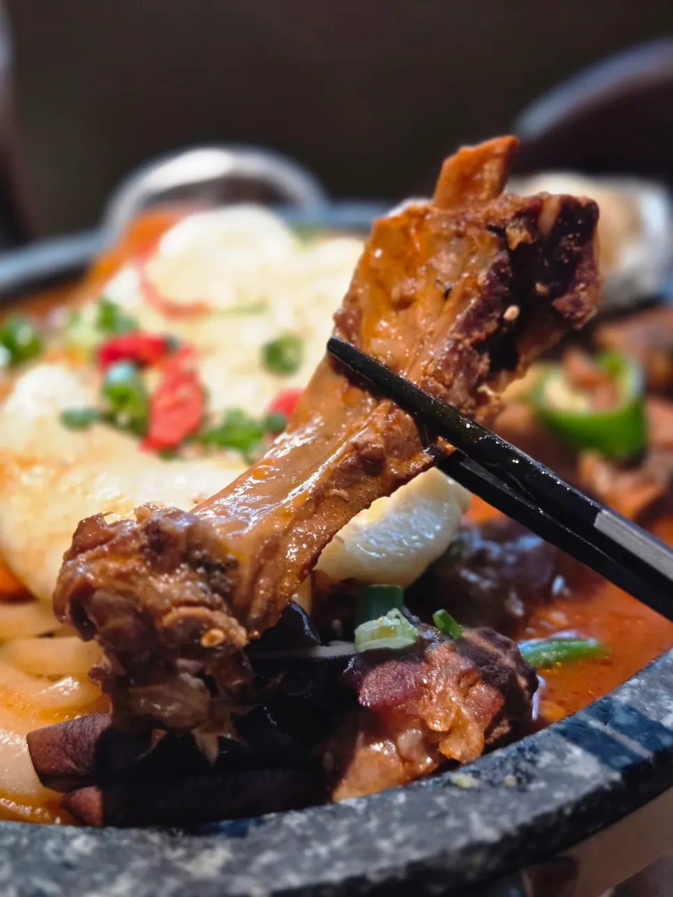 Spicy braised pork ribs simmering on the burner