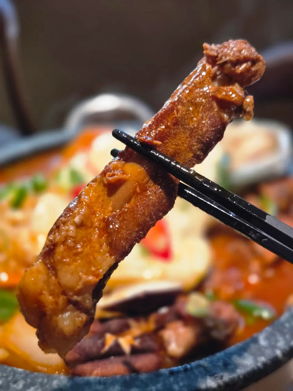 A pork rib with the meat falling off the bone