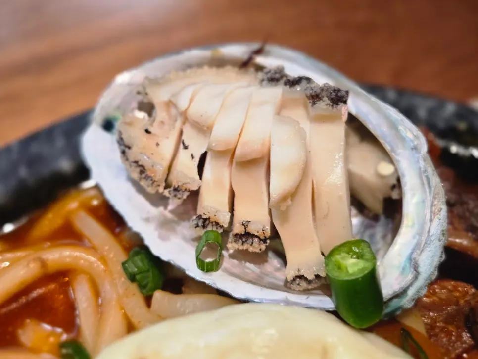 Trimmed abalone served alongside the pork rib stew