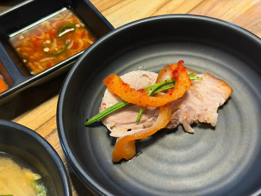 Table spread of steaming regular jokbal and spicy seasoned jokbal