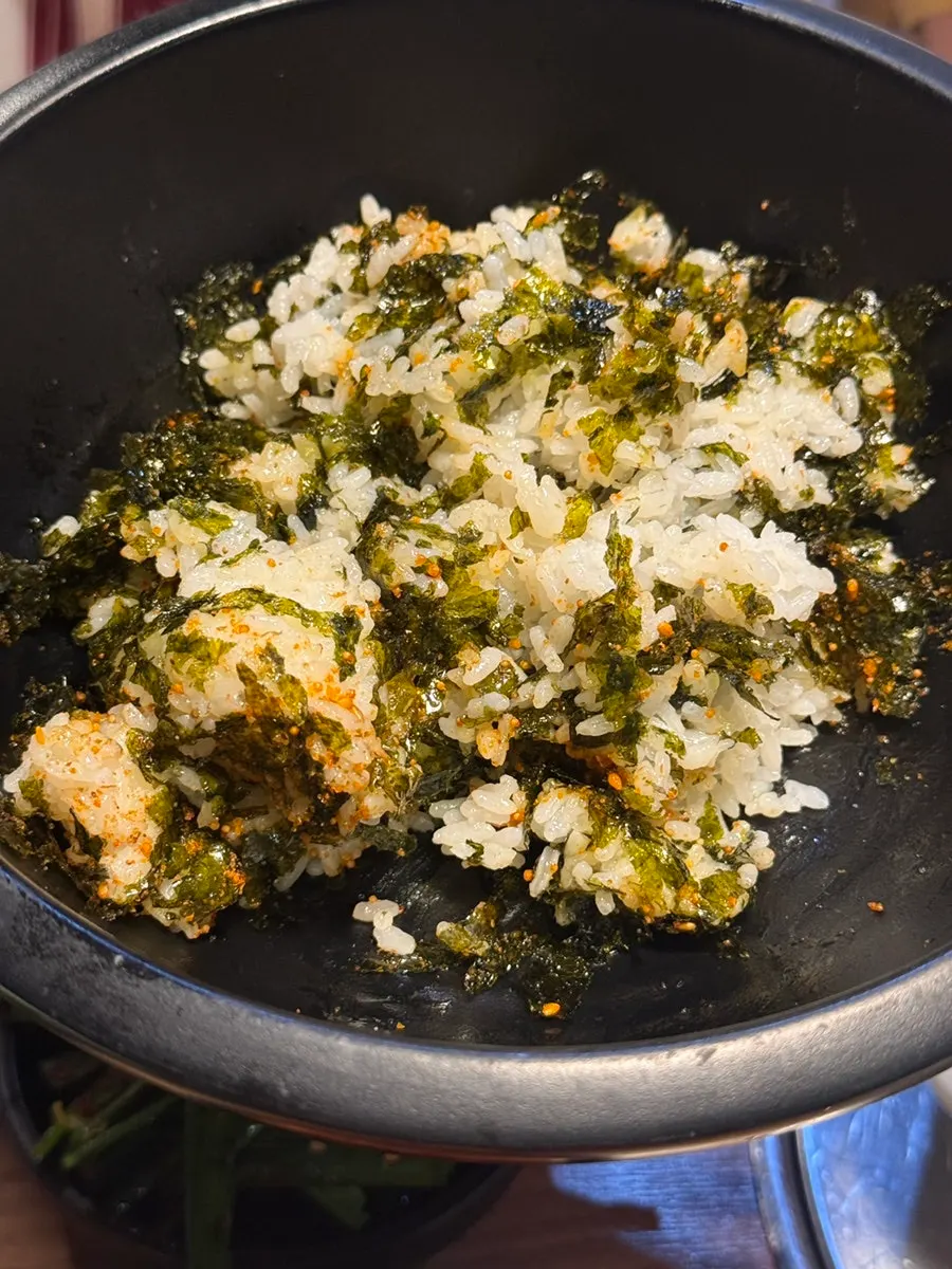 Rice ball topped with seaweed flakes and furikake