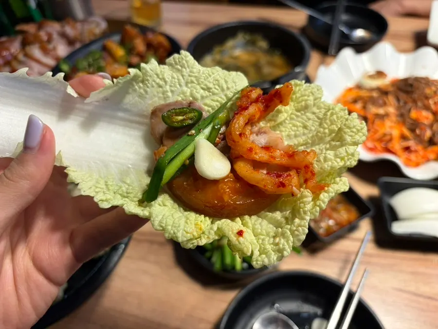A piece of jokbal on a cabbage wrap