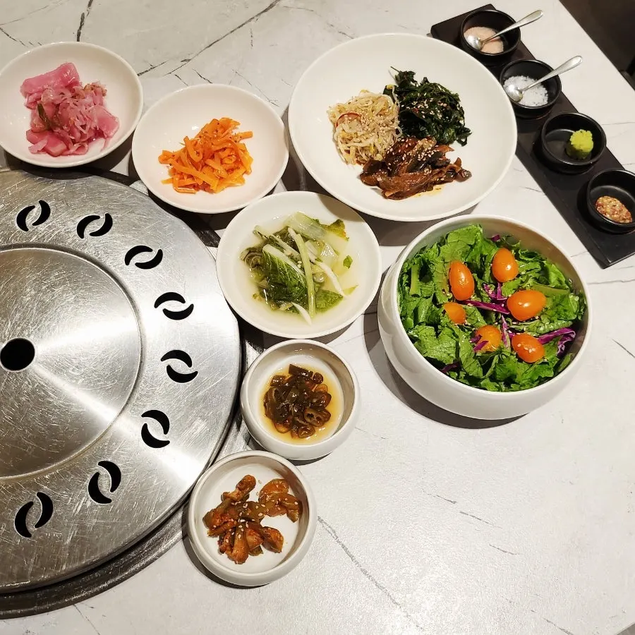 Korean beef BBQ spread laid out with Korean-made side dishes