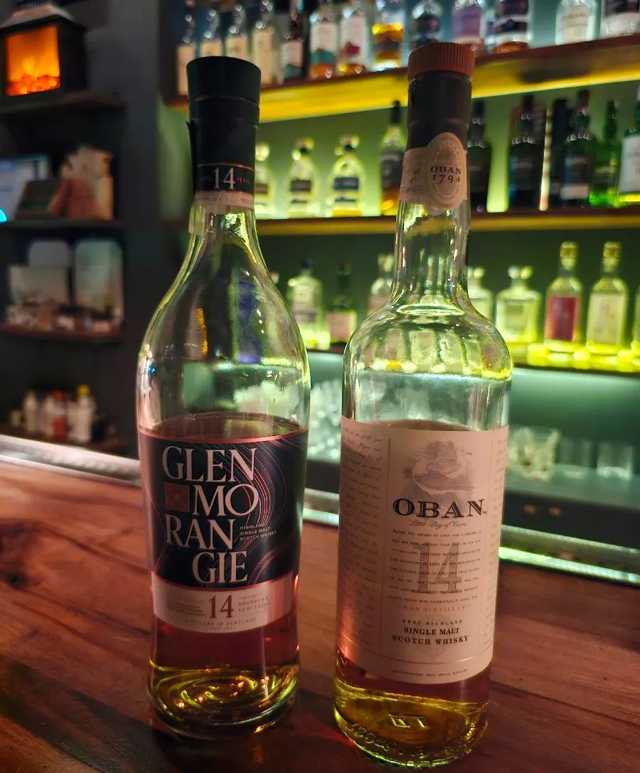 The owner-bartender's hands pouring whiskey