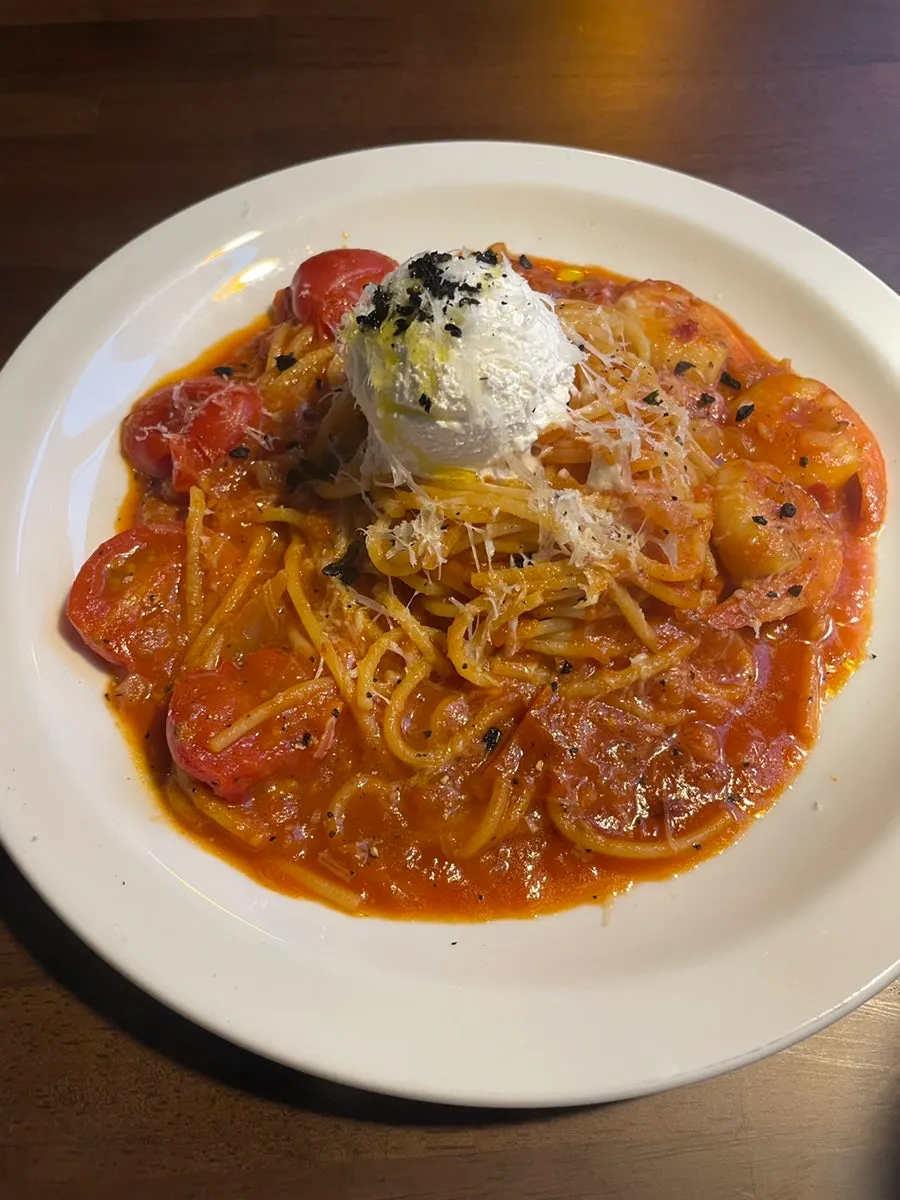 Tomato pasta topped with cherry tomatoes and cheese