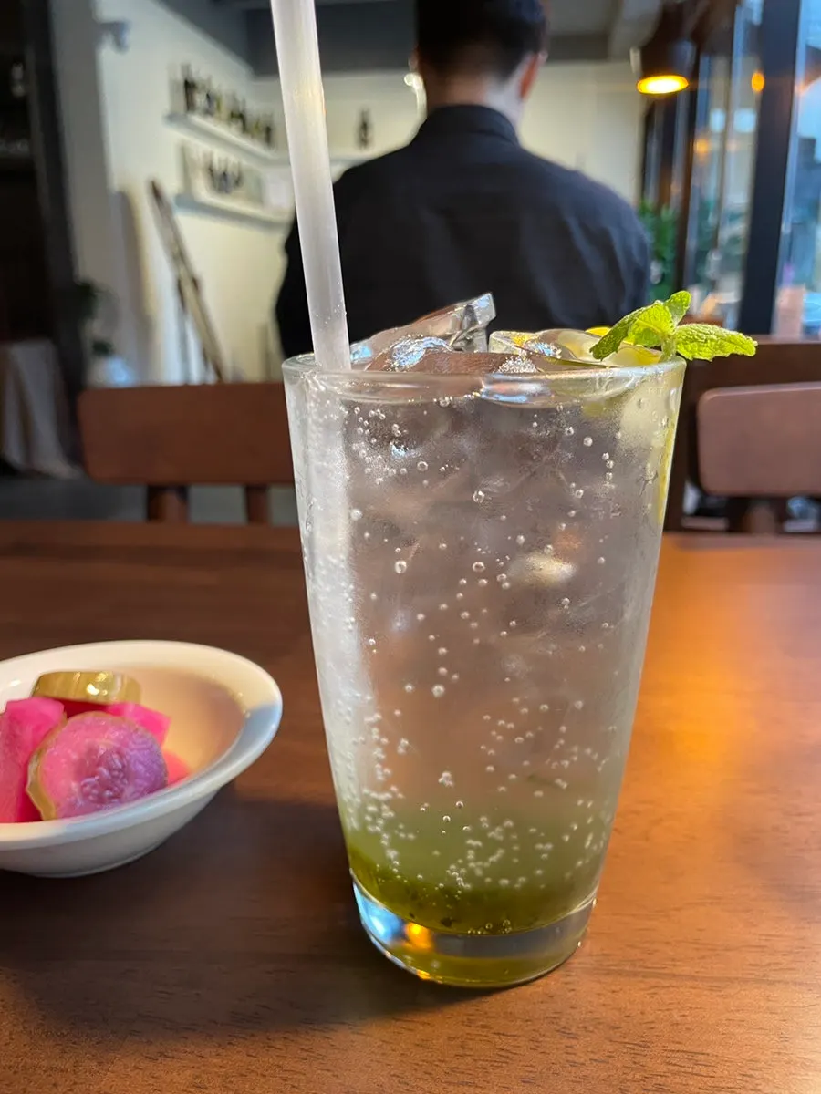A glass of soda served alongside the pasta