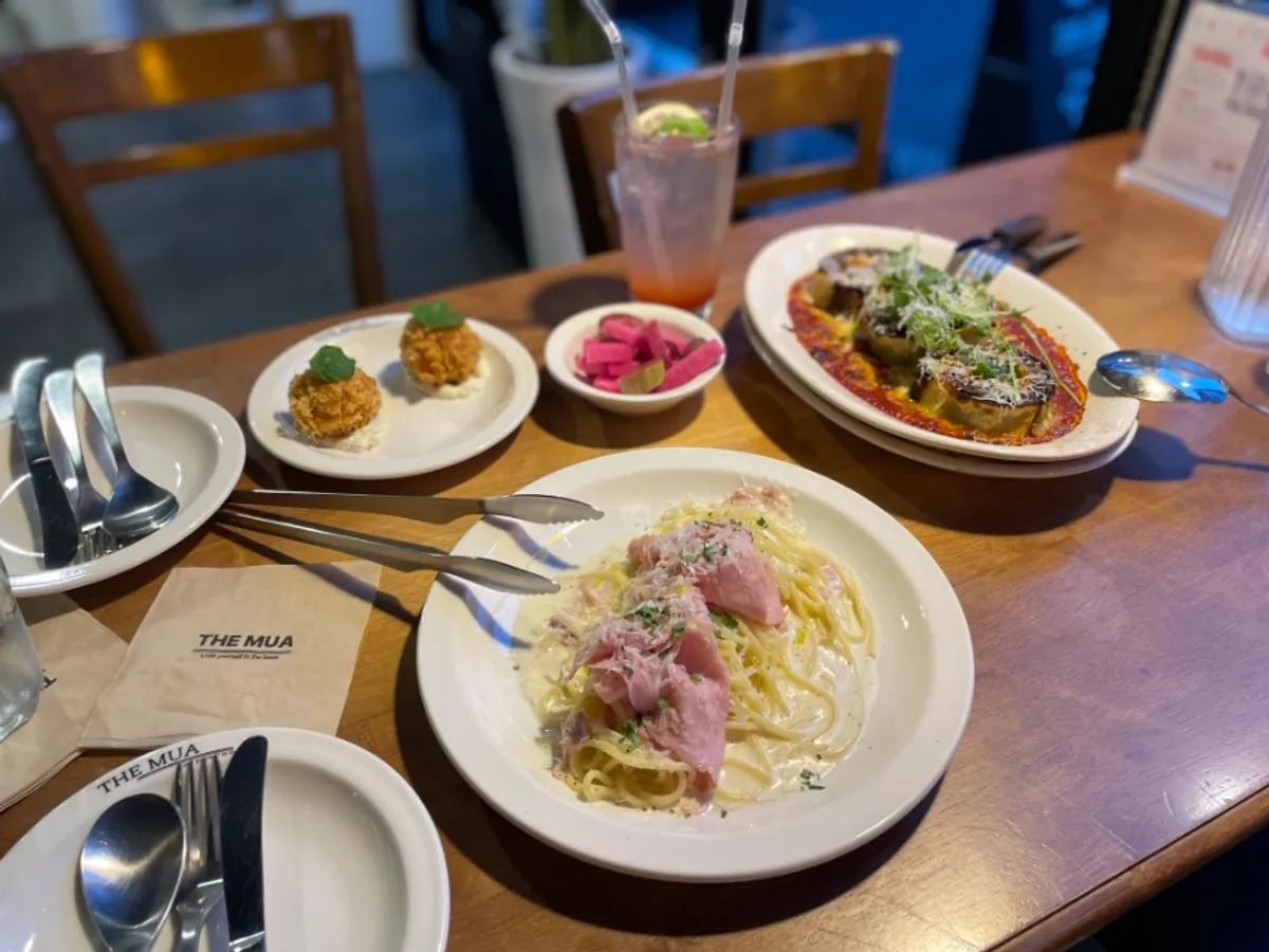 Full table spread of pasta and lasagna at THE MUA