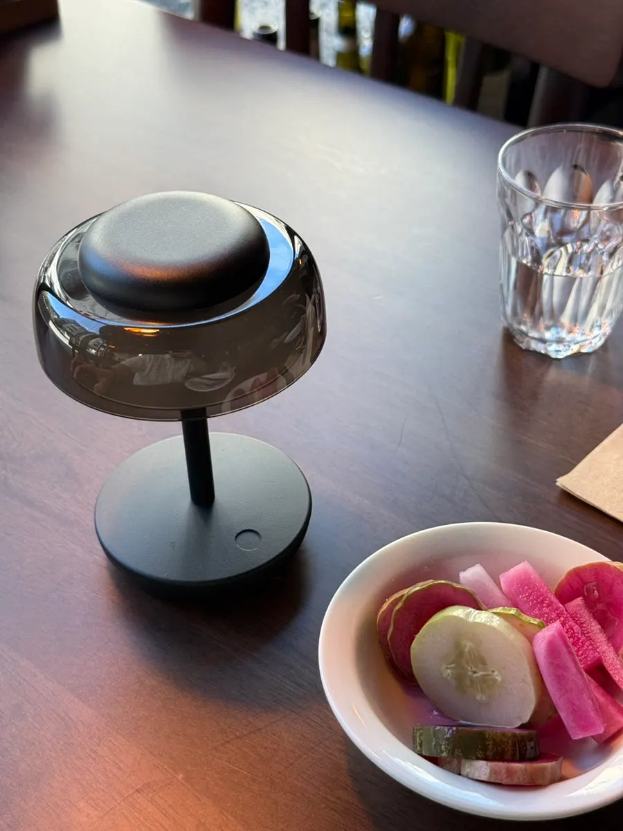 Two-person table at THE MUA with the lights on