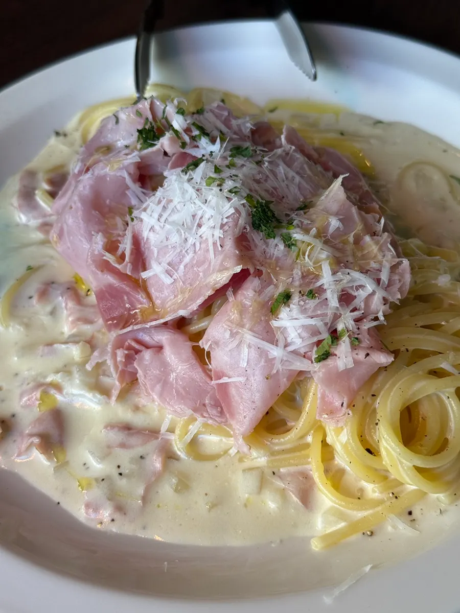 Pasta rolled with jambon in rich cream sauce