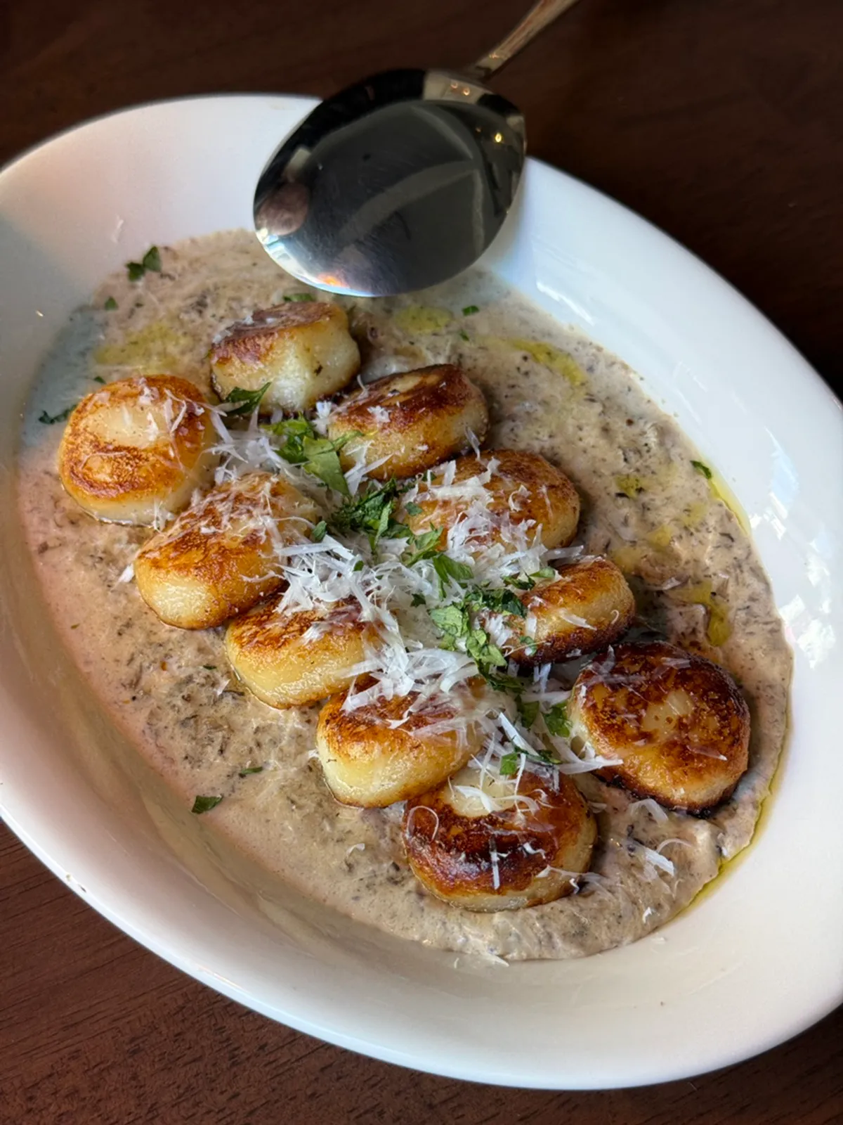 A plate of golden-roasted quattro mushroom gnocchi