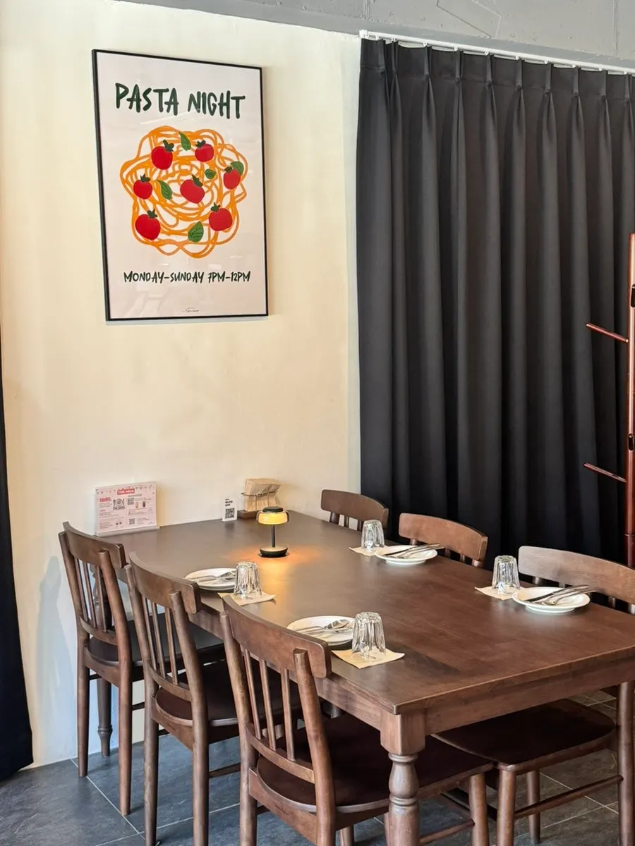 THE MUA's interior decorated with wine bottles and framed pictures