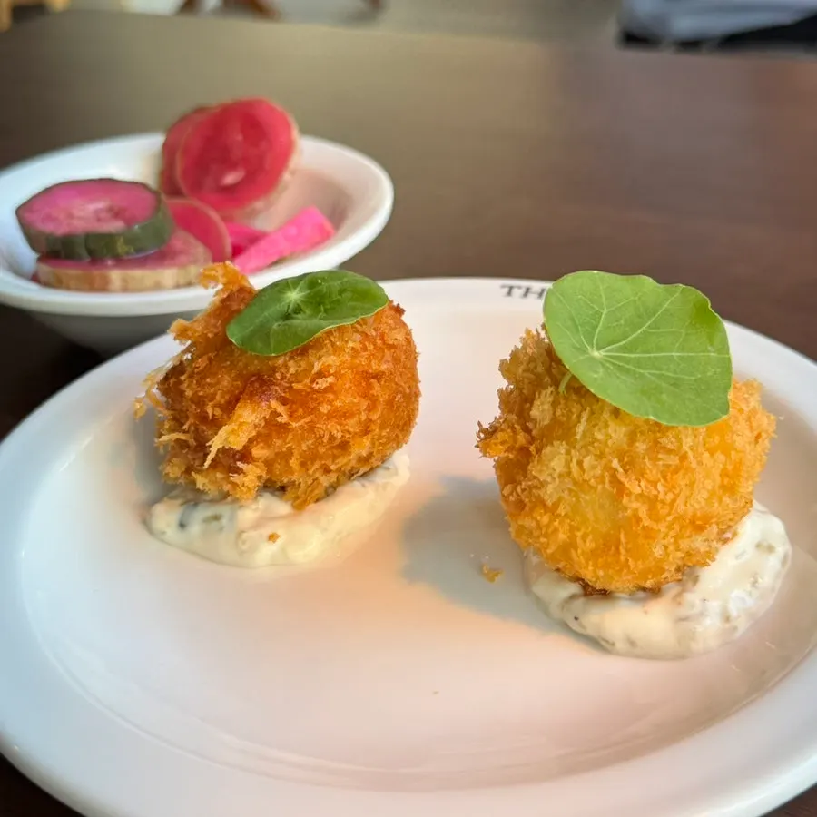 THE MUA's lobster croquettes garnished with nasturtium leaves