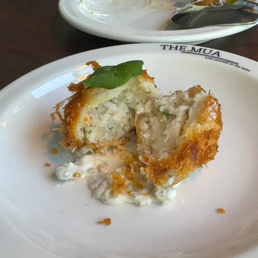 Lobster croquette plate with tartar sauce layered underneath