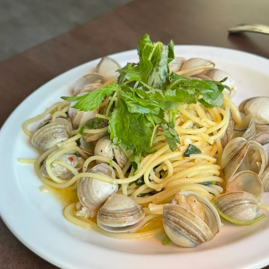 Chamnamul vongole pasta topped with surf clams and water dropwort