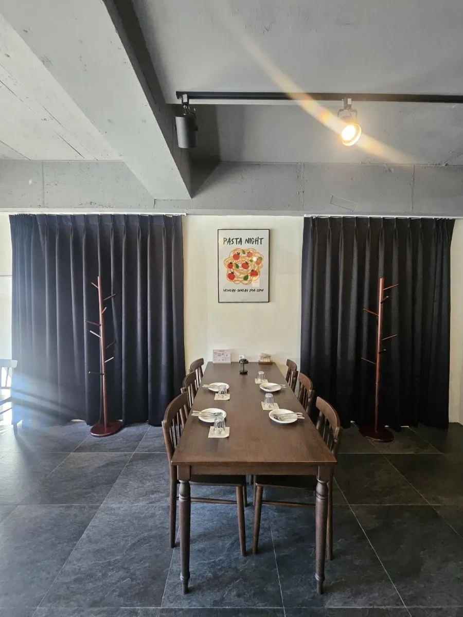 Interior of THE MUA's hall with wood tables