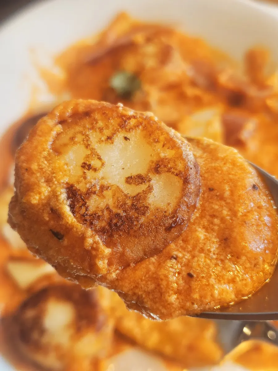 A bite of gnocchi soaked in rosé sauce