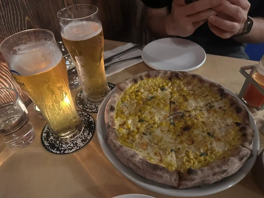 A slice of the sweet corn and taleggio pizza