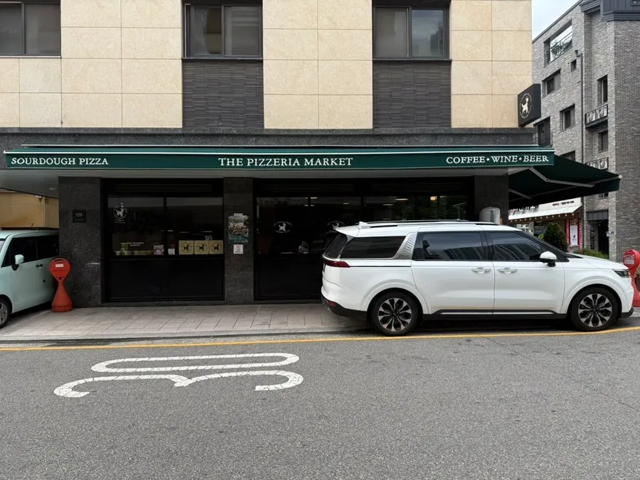 Parking space beside the store with a no-parking cone